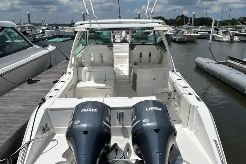 Slide: The Image of 2015 Pursuit DC 325 Dual Console boat docked with twin Yamaha engines. - 3