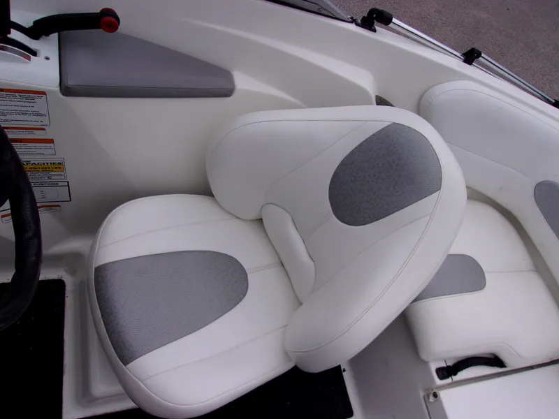Slide: The Image of 2010 Sea-Doo 180 Challenger SE boat interior with white and gray seating. - 11