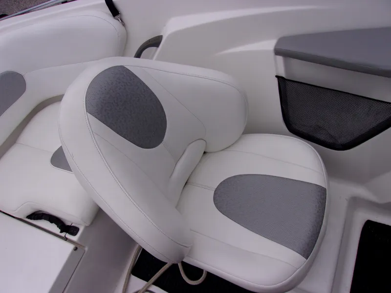 Slide: The Image of 2010 Sea-Doo 180 Challenger SE boat seat with white and gray upholstery. - 12