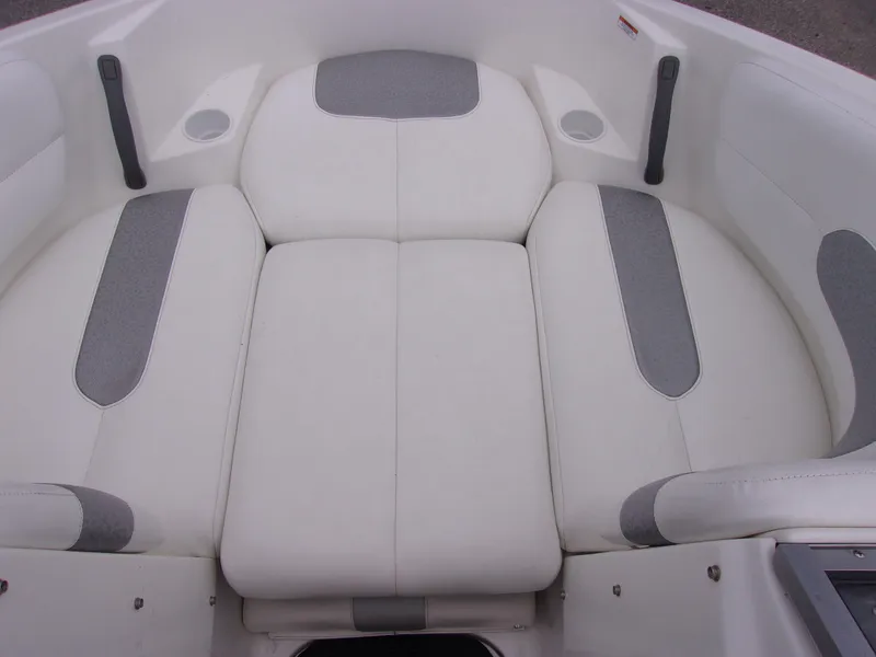 Slide: The Image of 2010 Sea-Doo 180 Challenger SE boat interior with white and gray cushioned seating. - 13