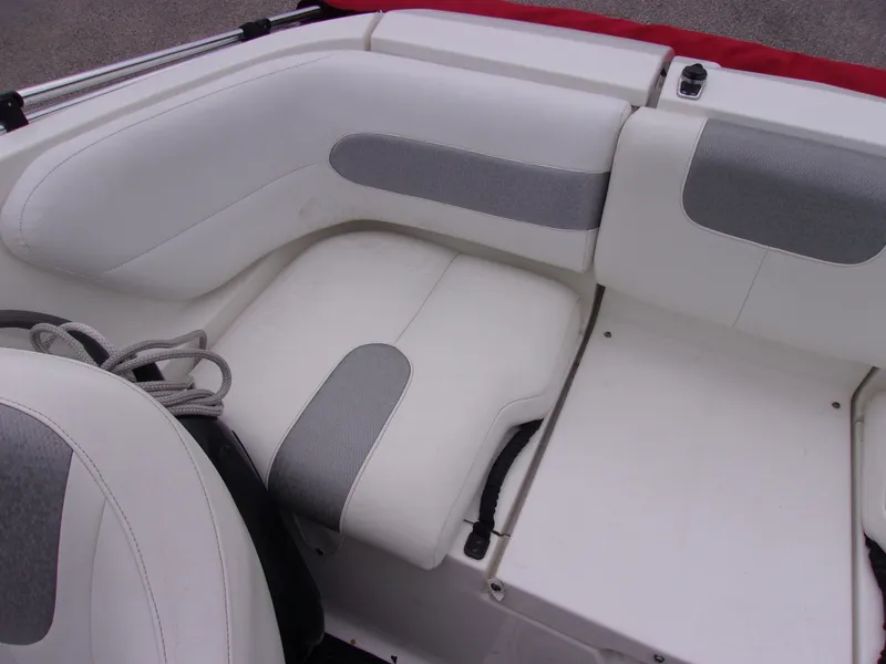 Slide: The Image of 2010 Sea-Doo 180 Challenger SE boat interior with white and gray seating. - 14