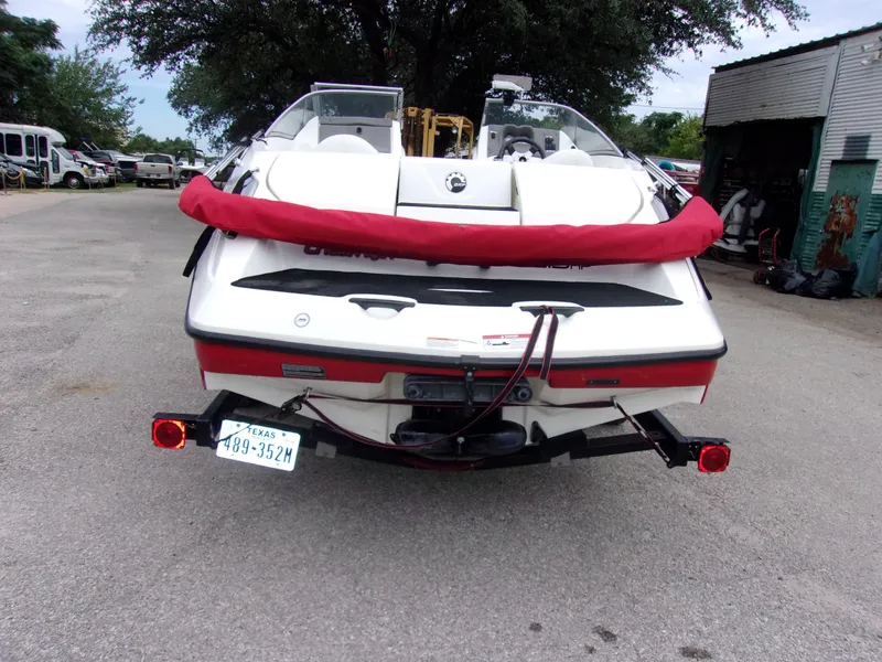 Slide: The Image of 2010 Sea-Doo 180 Challenger SE boat on trailer, rear view, parked outdoors. - 6