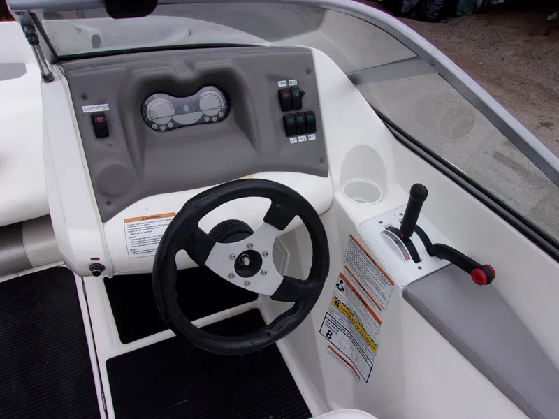 Slide: The Image of 2010 Sea-Doo 180 Challenger SE dashboard with steering wheel and control panel. - 9