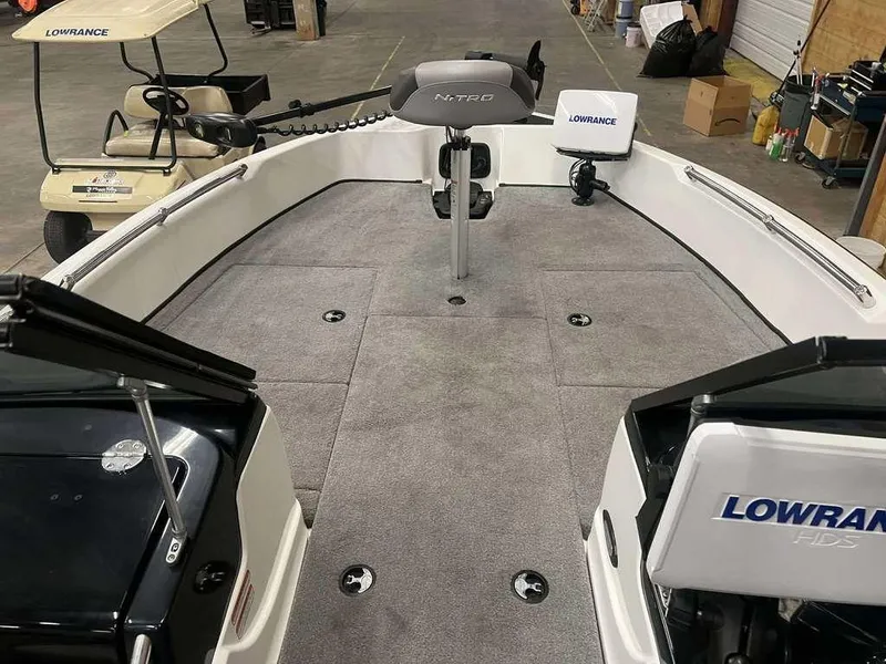 Slide: The Image of 2014 Nitro ZV 21 boat interior with Lowrance equipment and gray carpeted deck. - 2