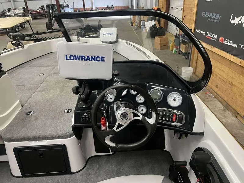 Slide: The Image of 2014 Nitro ZV 21 boat dashboard with Lowrance HDS system and steering wheel. - 3