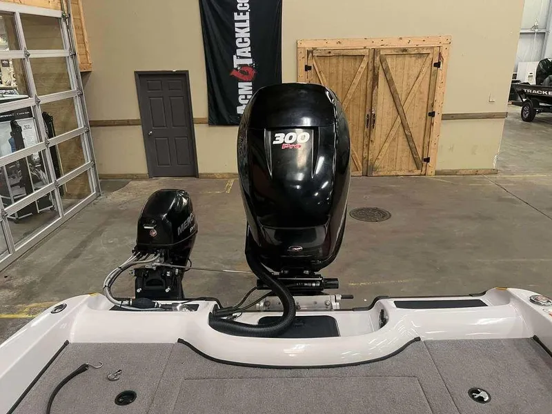 Slide: The Image of 2014 Nitro ZV 21 boat with dual Mercury outboard motors in a garage setting. - 6