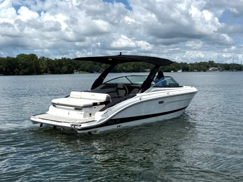Slide: The Image of 2026 Sea Ray SLX 280 on a calm lake with a cloudy sky. - 1