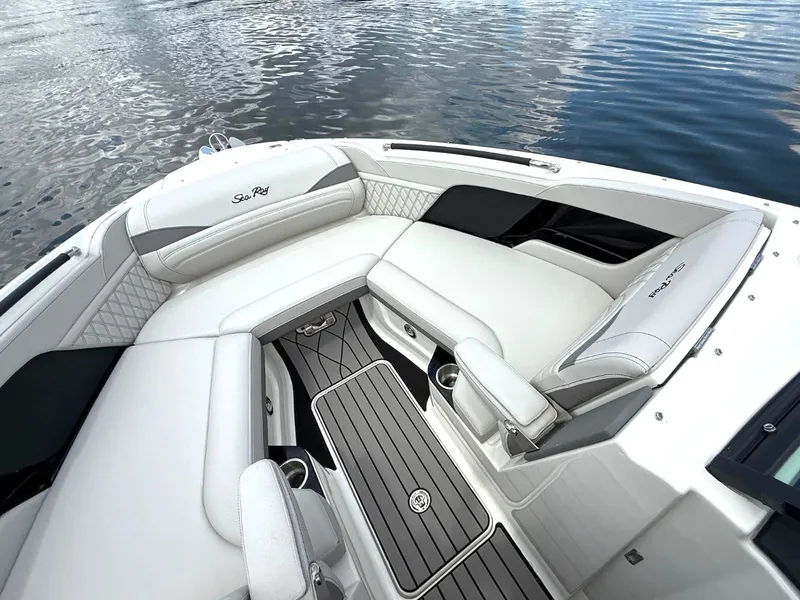Slide: The Image of The image shows the luxurious cockpit of a Sea Ray SLX 280 boat with sleek white upholstery. - 7