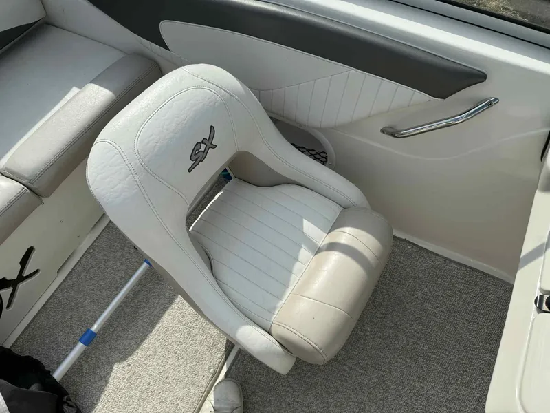 Slide: The Image of White leather seat in a 2006 Glastron SX 175 boat interior. - 10