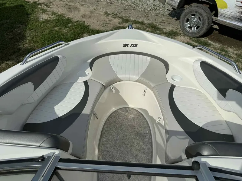 Slide: The Image of 2006 Glastron SX 175 boat interior with cushioned seating and carpeted floor. - 11