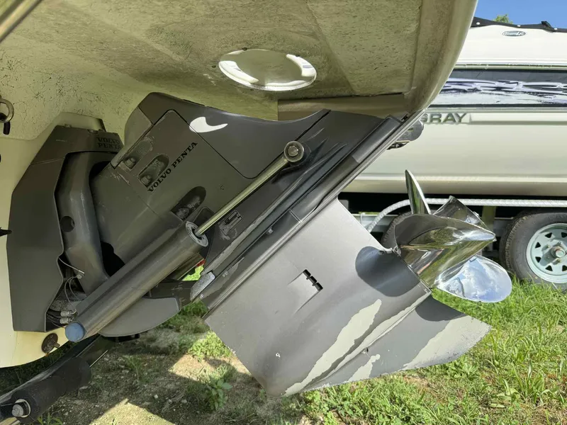 Slide: The Image of 2006 Glastron SX 175 boat with Volvo Penta outdrive and propeller, parked on grass. - 12