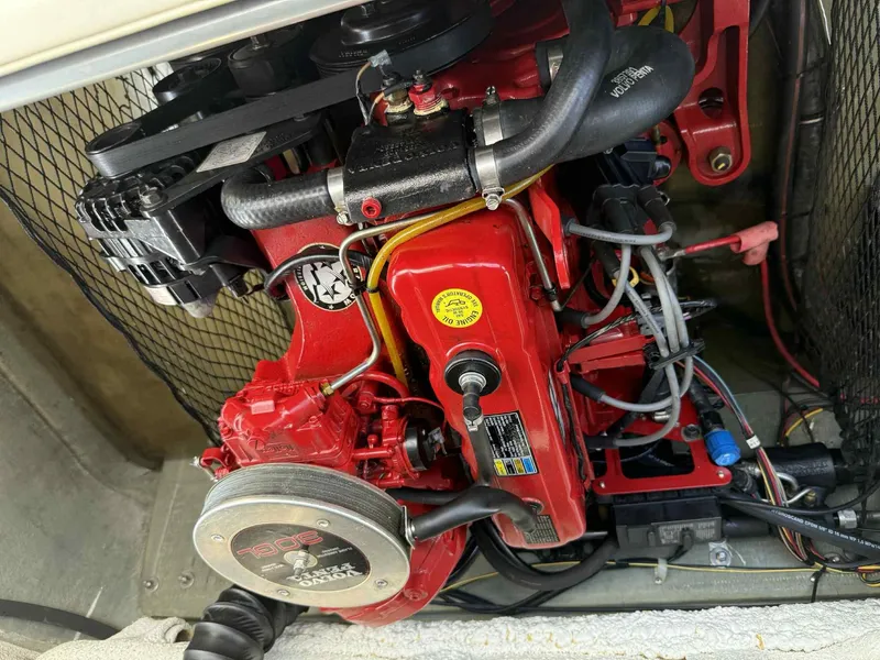 Slide: The Image of Engine of a 2006 Glastron SX 175 boat, featuring red components and visible wiring. - 13