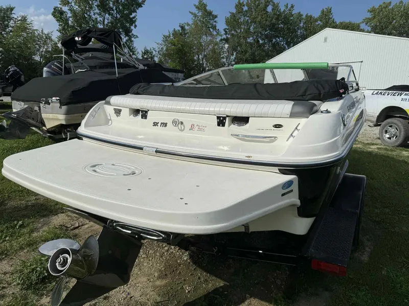 Slide: The Image of 2006 Glastron SX 175 boat on trailer, rear view, parked outdoors. - 2