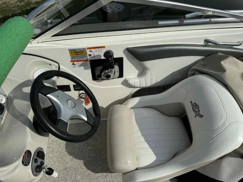 Slide: The Image of 2006 Glastron SX 175 boat interior with steering wheel and seat. - 9