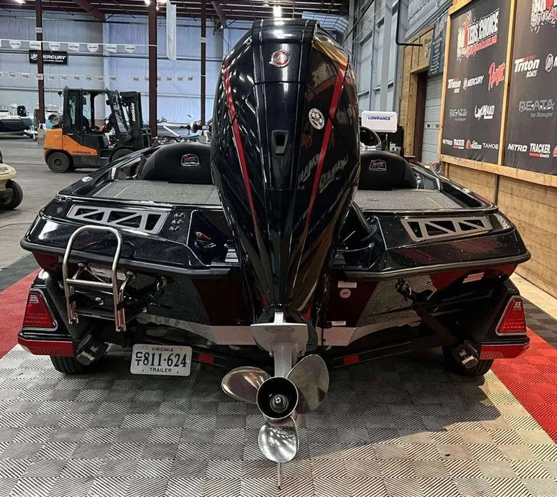 Slide: The Image of 2022 Ranger Z519 boat with powerful outboard motor in showroom setting. - 2