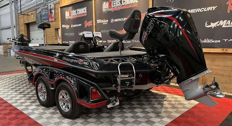 Slide: The Image of 2022 Ranger Z519 boat with powerful outboard motor on display indoors. - 3