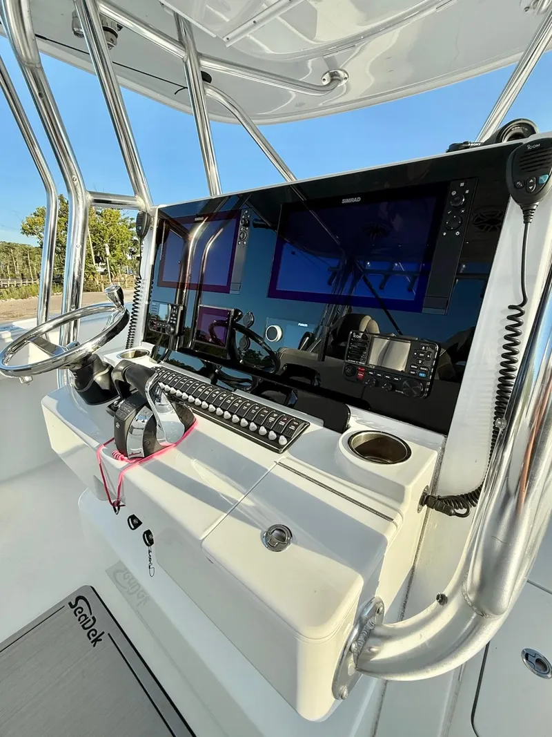 Slide: The Image of Control panel of 2023 Freeman 34VH boat with steering wheel and navigation screens. - 17
