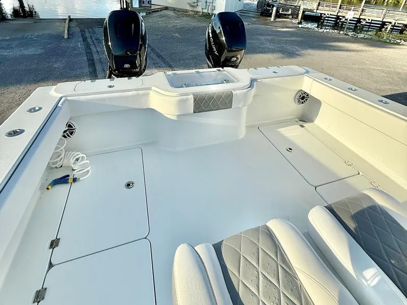 Slide: The Image of 2023 Freeman 34VH boat interior with dual engines, spacious deck, and cushioned seating. - 20