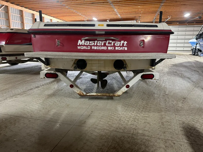 Slide: The Image of 1993 MasterCraft ProStar 190 boat in storage, rear view, showcasing "World Record Ski Boats" branding. - 5