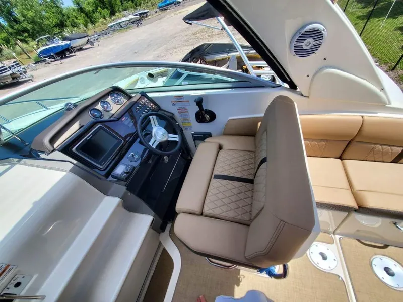 Slide: The Image of 2017 Sea Ray 260 Sundancer cockpit with beige seating and modern dashboard controls. - 3