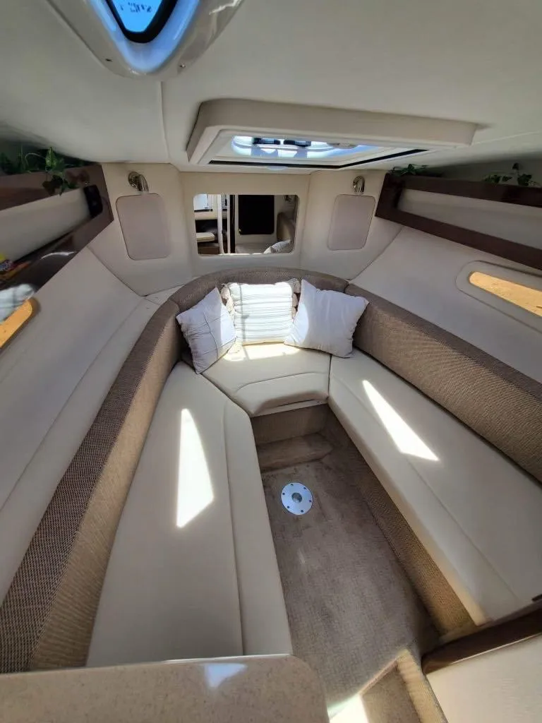Slide: The Image of Interior cabin of 2017 Sea Ray 260 Sundancer with beige seating and cushions. - 4