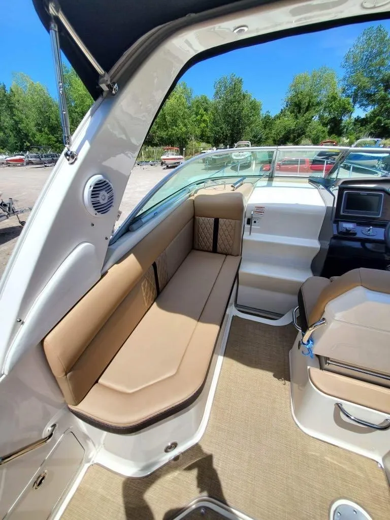 Slide: The Image of 2017 Sea Ray 260 Sundancer interior with tan seating and modern dashboard. - 6