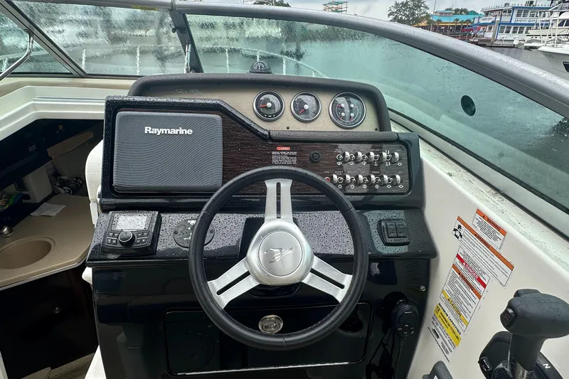 Slide: The Image of 2017 Sea Ray 260 Sundancer helm with Raymarine navigation system and control panel. - 9