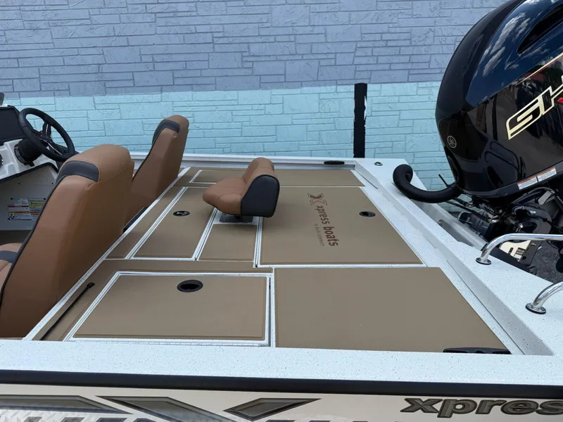 Slide: The Image of 2026 Xpress H20 Bass boat interior with tan seating and storage compartments. - 6