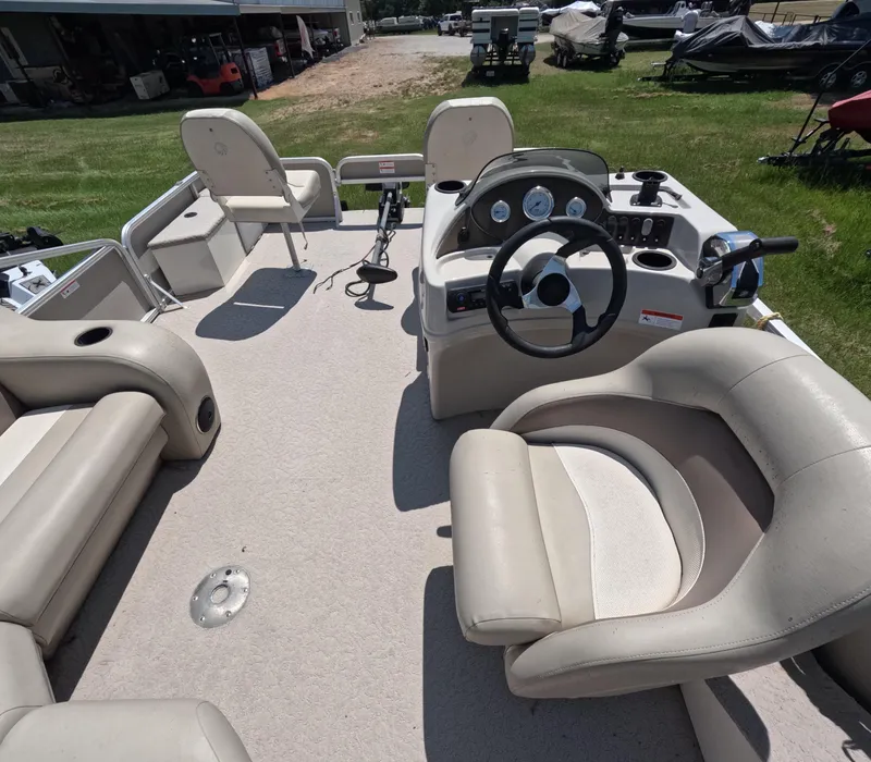Slide: The Image of 2011 Lowe Suncruiser SF214 pontoon boat interior with steering console and seating. - 10