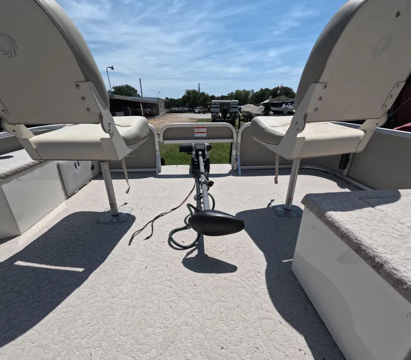 Slide: The Image of 2011 Lowe Suncruiser SF214 boat interior with two seats and trolling motor. - 11