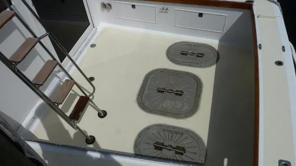 Slide: The Image of 1987 Duffy Flybridge Cruiser deck with ladder and storage hatches. - 10