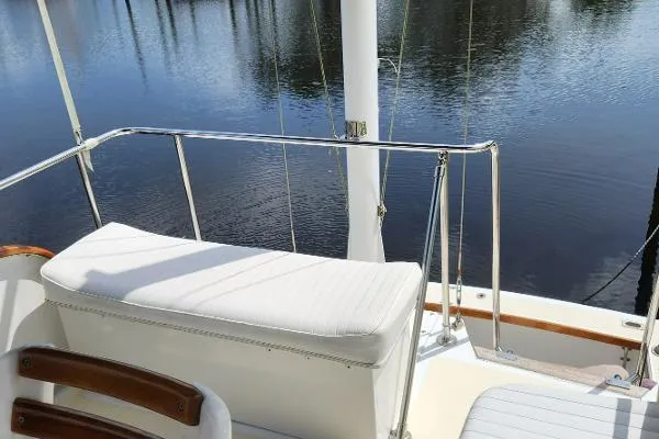 Slide: The Image of 1987 Duffy Flybridge Cruiser with white seating, overlooking calm water. - 11