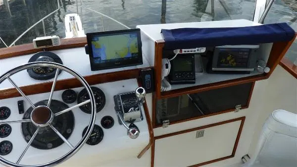 Slide: The Image of 1987 Duffy Flybridge Cruiser helm with navigation equipment and steering wheel. - 14
