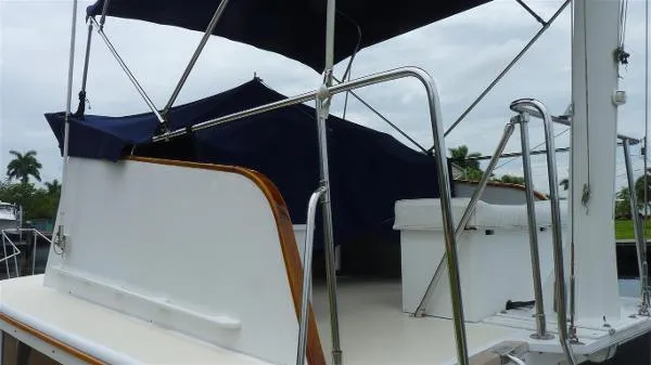 Slide: The Image of 1987 Duffy Flybridge Cruiser with blue canopy and stainless steel railings. - 20
