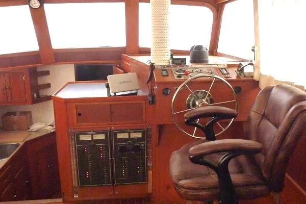 Slide: The Image of 1987 Duffy Flybridge Cruiser helm with wooden interior and captain's chair. - 22