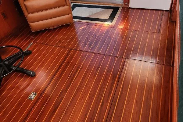 Slide: The Image of 1987 Duffy Flybridge Cruiser interior with polished wooden flooring and leather seating. - 25
