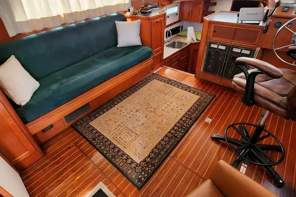 Slide: The Image of Interior of a 1987 Duffy Flybridge Cruiser with wooden flooring and cozy seating. - 30