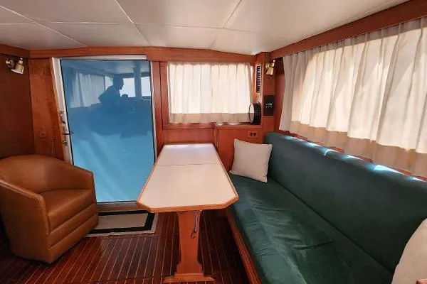 Slide: The Image of Interior of 1987 Duffy Flybridge Cruiser with sofa, table, and armchair. - 31