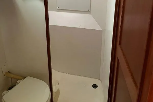 Slide: The Image of 1987 Duffy Flybridge Cruiser bathroom with toilet and shower area. - 35