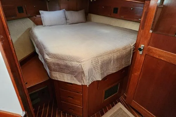 Slide: The Image of Cozy cabin interior of 1987 Duffy Flybridge Cruiser with wooden furnishings and a comfortable bed. - 36