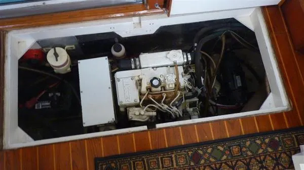 Slide: The Image of Engine compartment of a 1987 Duffy Flybridge Cruiser, showcasing mechanical components and wiring. - 39