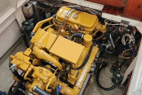 Slide: The Image of Engine room of a 1987 Duffy Flybridge Cruiser with a yellow engine. - 40