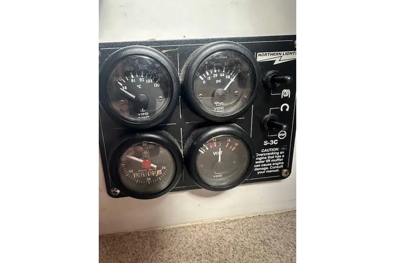 Slide: The Image of 1987 Duffy Flybridge Cruiser control panel with gauges and switches. - 41