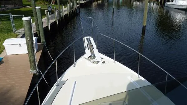 Slide: The Image of 1987 Duffy Flybridge Cruiser docked at a marina, view from the bow. - 6
