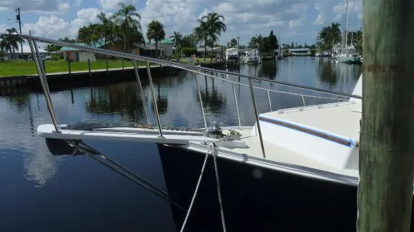 Slide: The Image of 1987 Duffy Flybridge Cruiser docked in a serene canal with palm trees. - 7