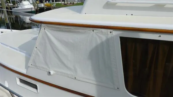 Slide: The Image of 1987 Duffy Flybridge Cruiser with white canvas cover on the side window. - 8