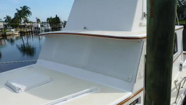 Slide: The Image of 1987 Duffy Flybridge Cruiser docked near palm trees and waterfront homes. - 9