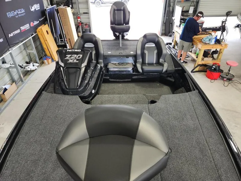 Slide: The Image of 2026 Nitro Z20 XL Pro boat interior in a garage with seating and equipment. - 11