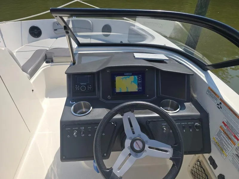 Slide: The Image of 2022 Bayliner VR6 Bowrider OB dashboard with steering wheel and navigation display. - 3