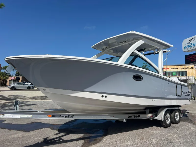 The Image of 2025 Robalo R257 Dual Console boat on trailer under clear blue sky. - 0